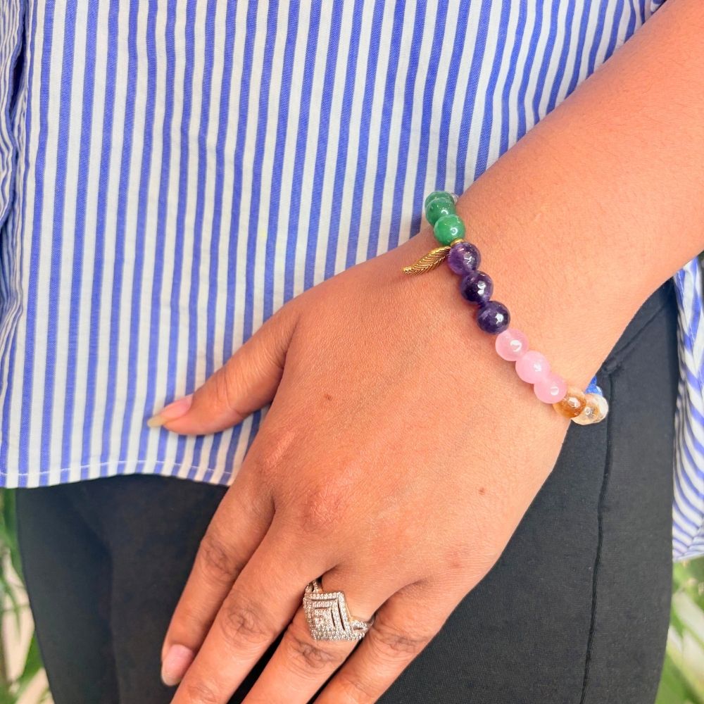 woman wearing a 7 Chakra Crystal bracelet on her left hand