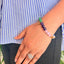 woman wearing a 7 Chakra Crystal bracelet on her left hand
