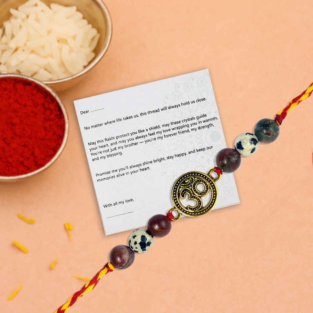Rakhi with a message card on a peach background