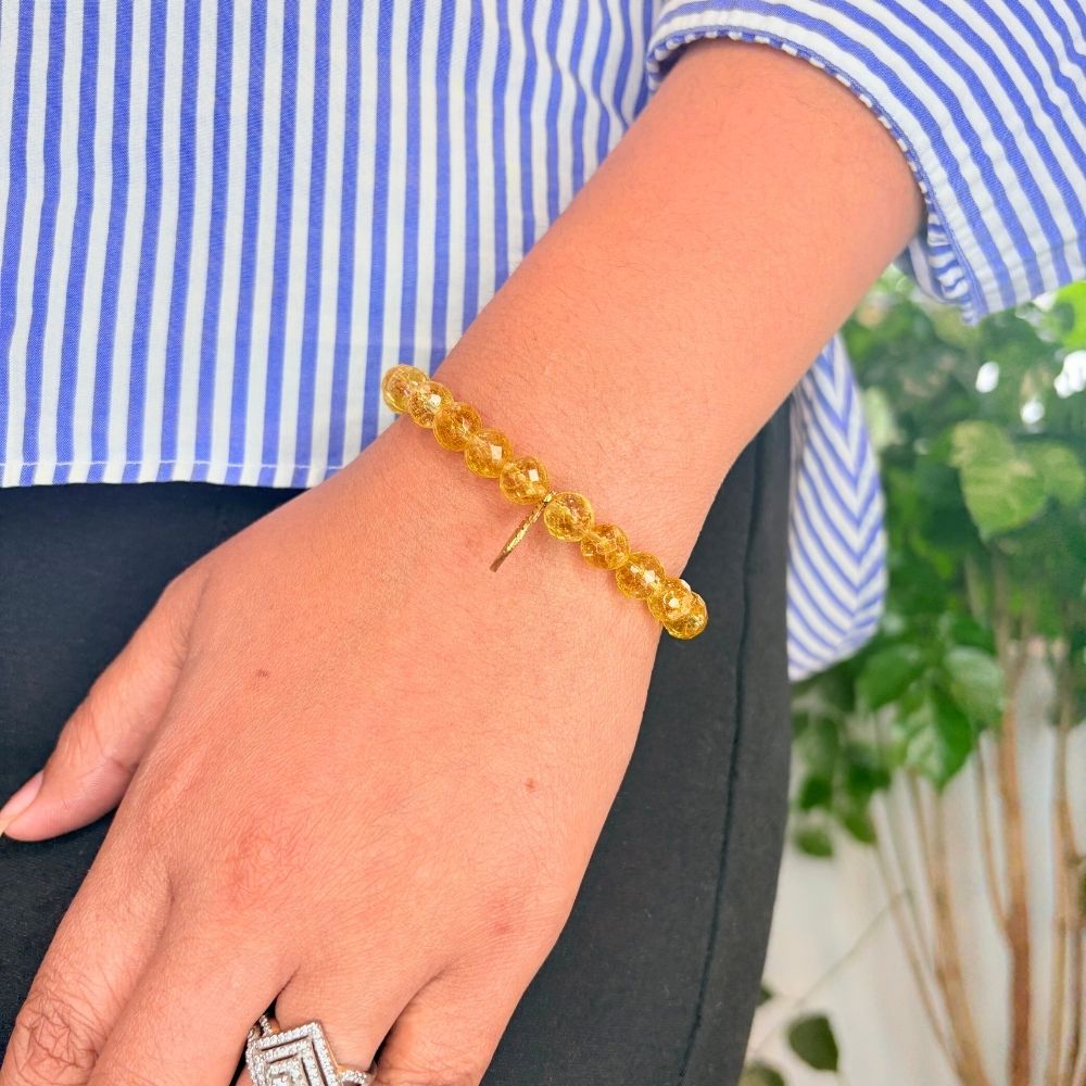 woman wearing Citrine Charm Bracelet on left hand