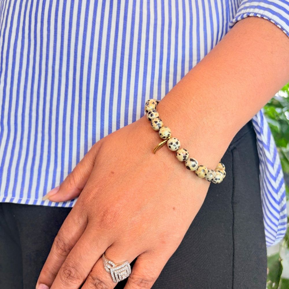 woman wearing a Dalmatian Jasper bracelet on her left hand