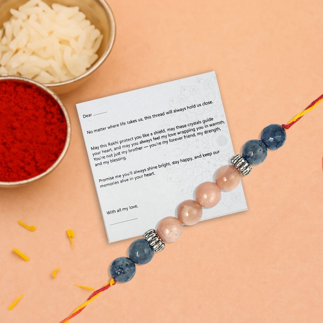 crystal Rakhi with thankyou card on a peach background