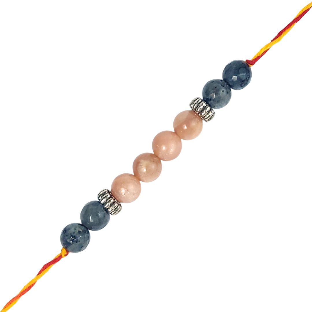 rakhi with blue and pink beads on a white background