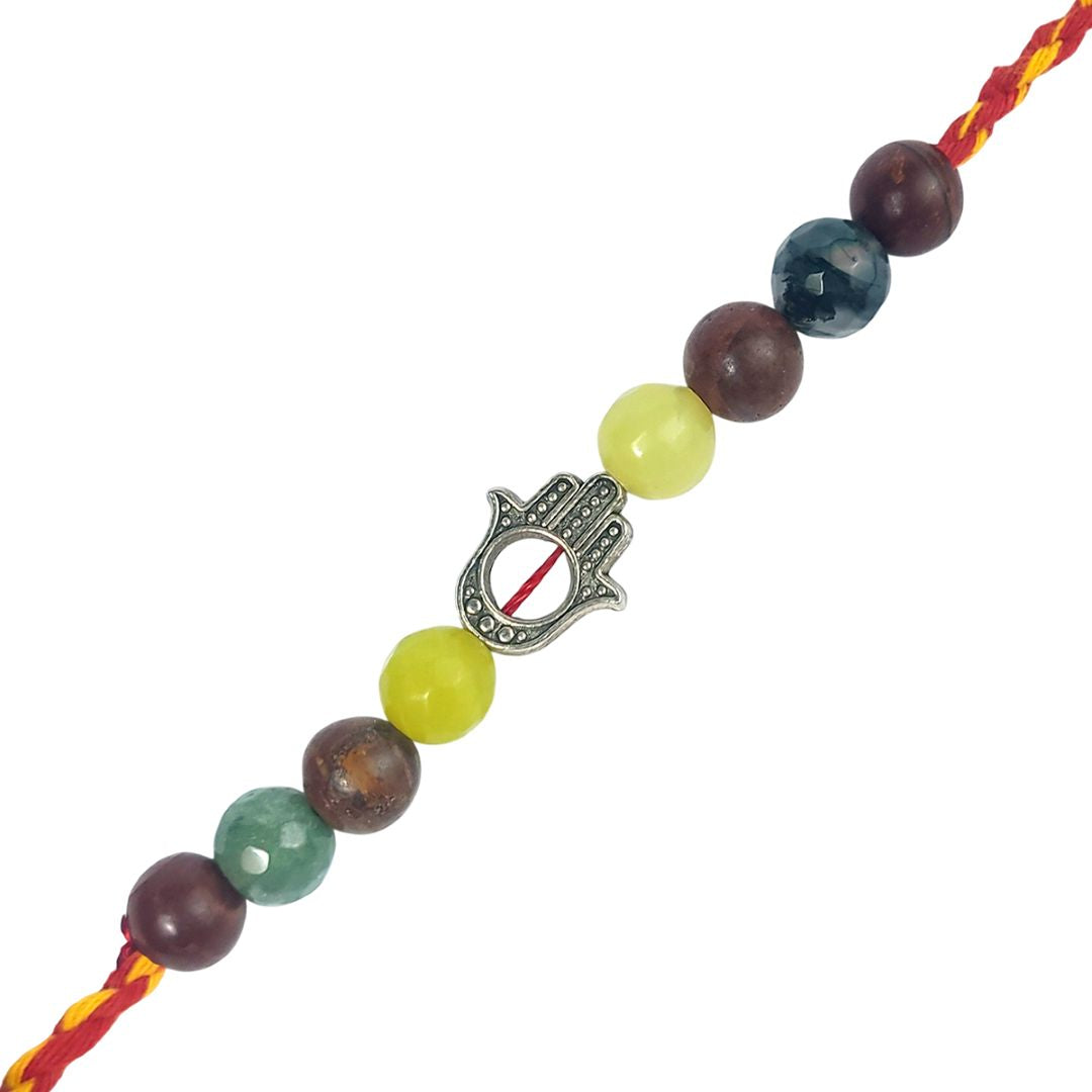 rakhi with multicolored beads and a silver Hamsa charm on a white background