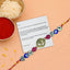 Decorative rakhi with beads and a card on a peach background
