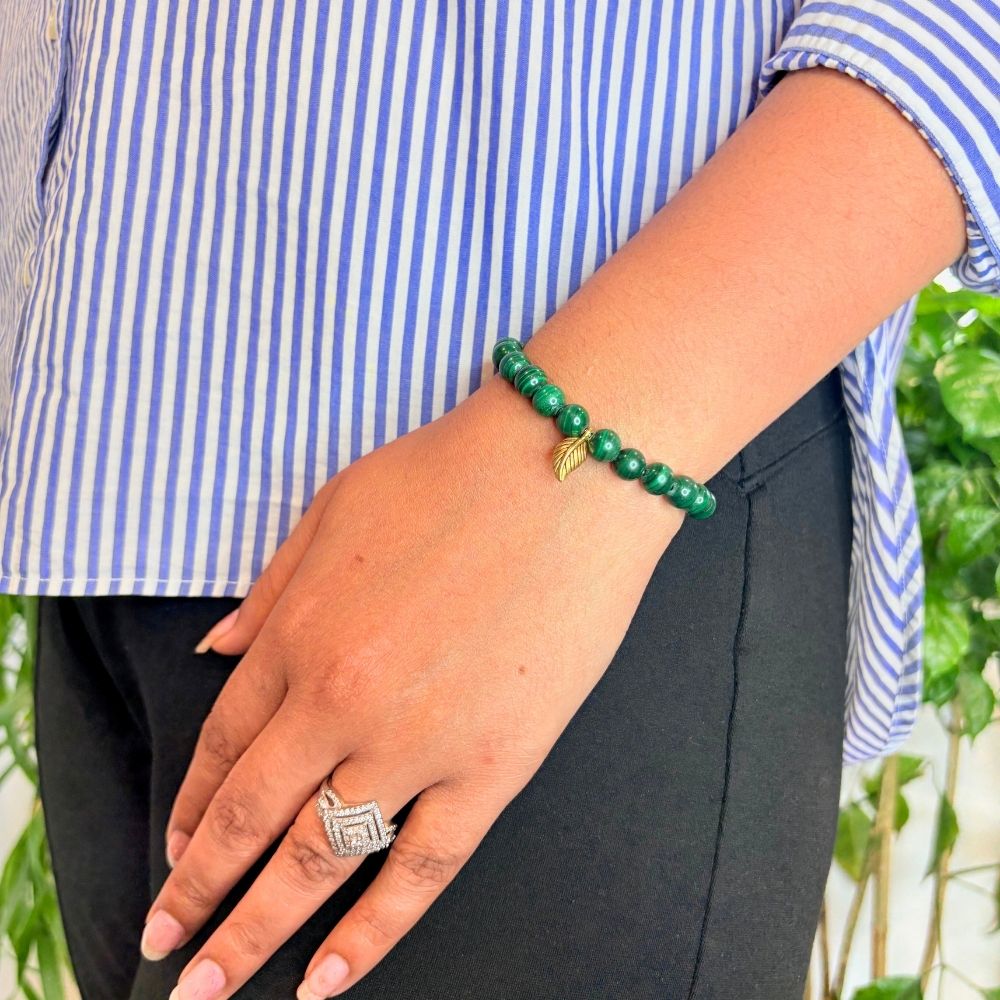 woman wearing a Malachite healing bracelet on her left hand