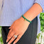 woman wearing a Malachite healing bracelet on her left hand