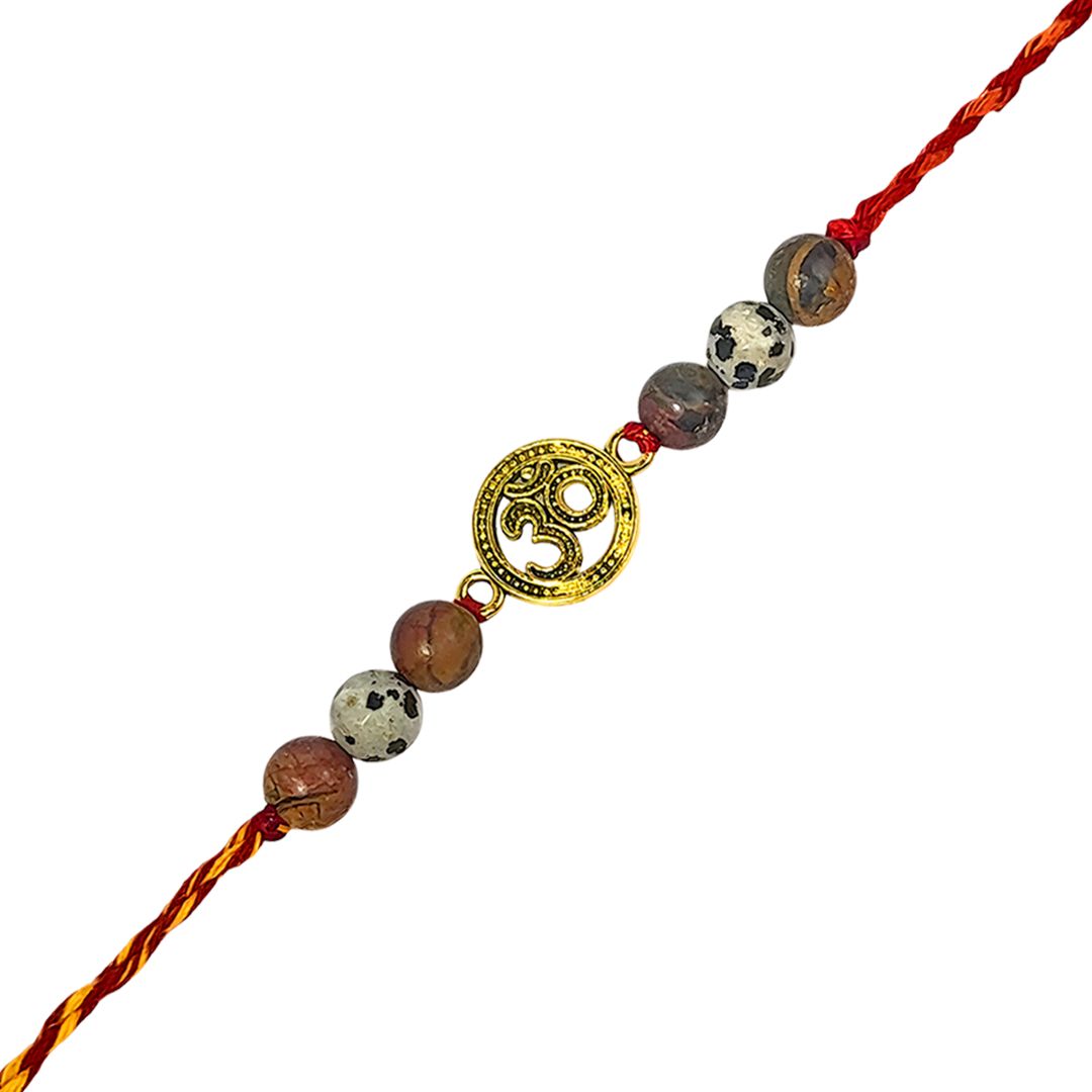 rakhi with beads and a gold charm on a white background