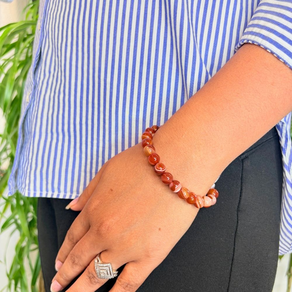 woman wearing a Natural Carnelian bracelet on her left hand