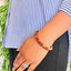 woman wearing a Natural Carnelian bracelet on her left hand