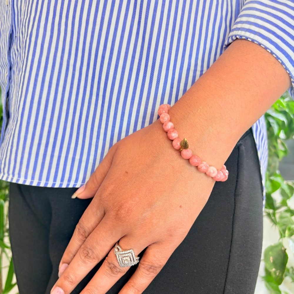 woman wearing a Peach Moonstone Crystal bracelet on her left hand