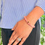 woman wearing a Peach Moonstone Crystal bracelet on her left hand