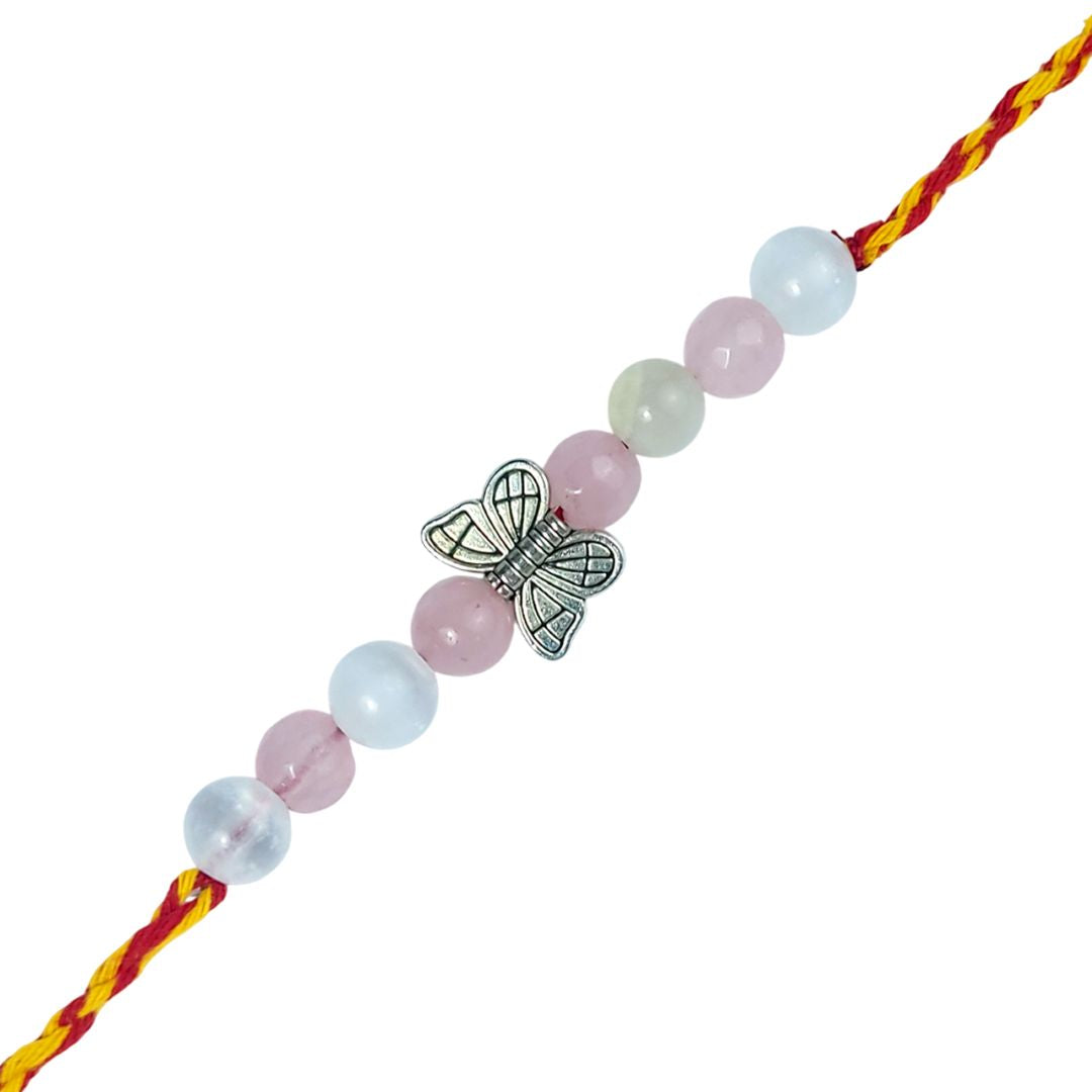 rakhi with beads and a butterfly charm on a white background