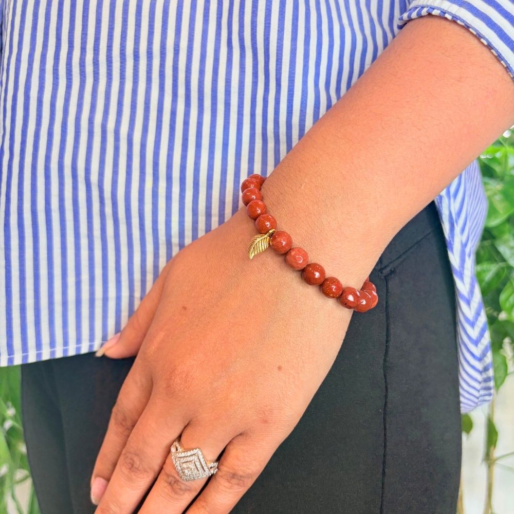 woman wearing a Red Jasper Healing bracelet on her left hand