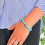 woman wearing a Turquoise Leaf Charm bracelet on her left hand