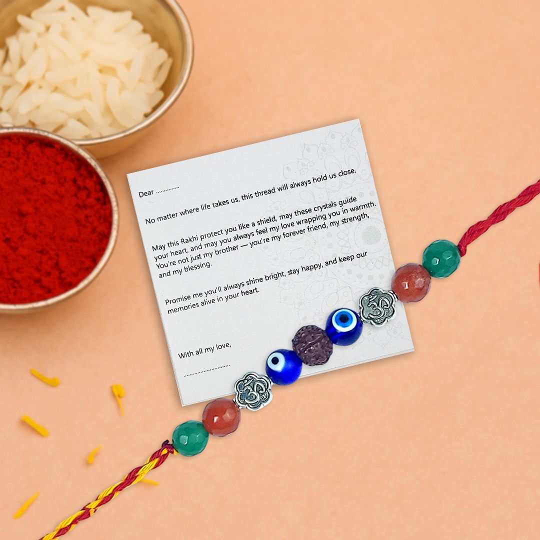 Colorful beaded Rakhi with a letter on a peach background