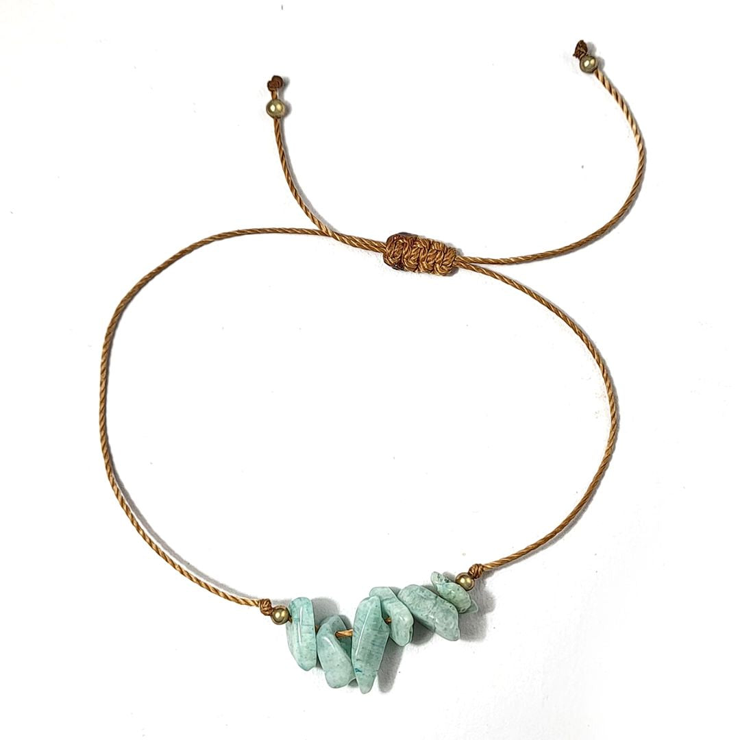 Bracelet with amazonite stones and gold accents on a white background