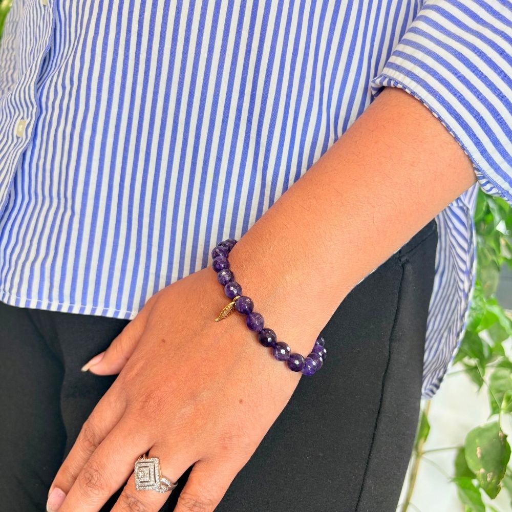 woman wearing a Amethyst Crystal bracelet on her left hand