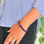 woman wearing a Amethyst Crystal bracelet on her left hand