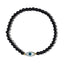 Black beaded bracelet with an eye-shaped charm on a white background
