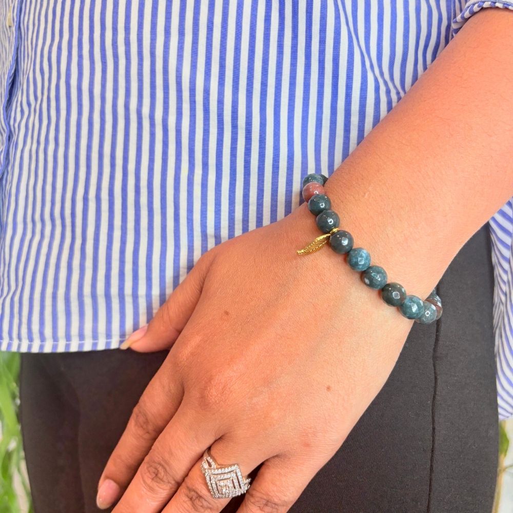 woman wearing a Natural Bloodstone Bracelet on her left hand