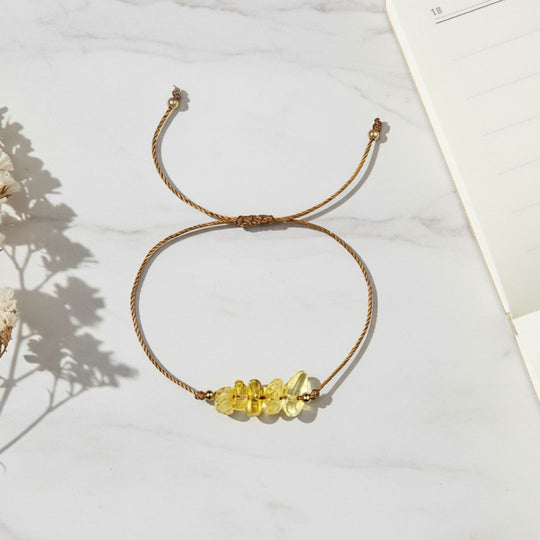 Bracelet with yellow beads on a light surface