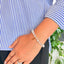 woman wearing a Clear Quartz Crystal Bracelet With Charm on her left hand