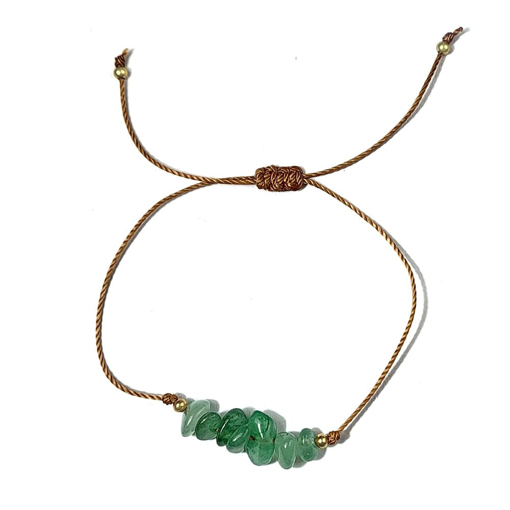 green avnturine crystal thread bracelet on a white surface