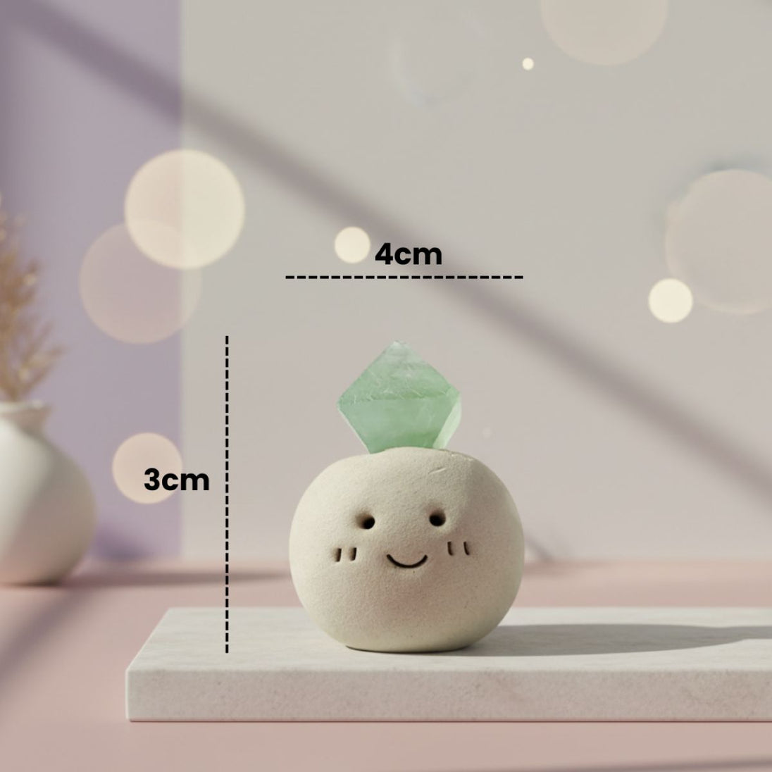 Small decorative stone with a green jade crystal on top, labeled with dimensions, against a soft blurred background.