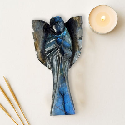 Labradorite Angel figurine with candle, styled home decor setting