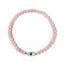 Pink beaded bracelet with a blue evil eye charm on a white background