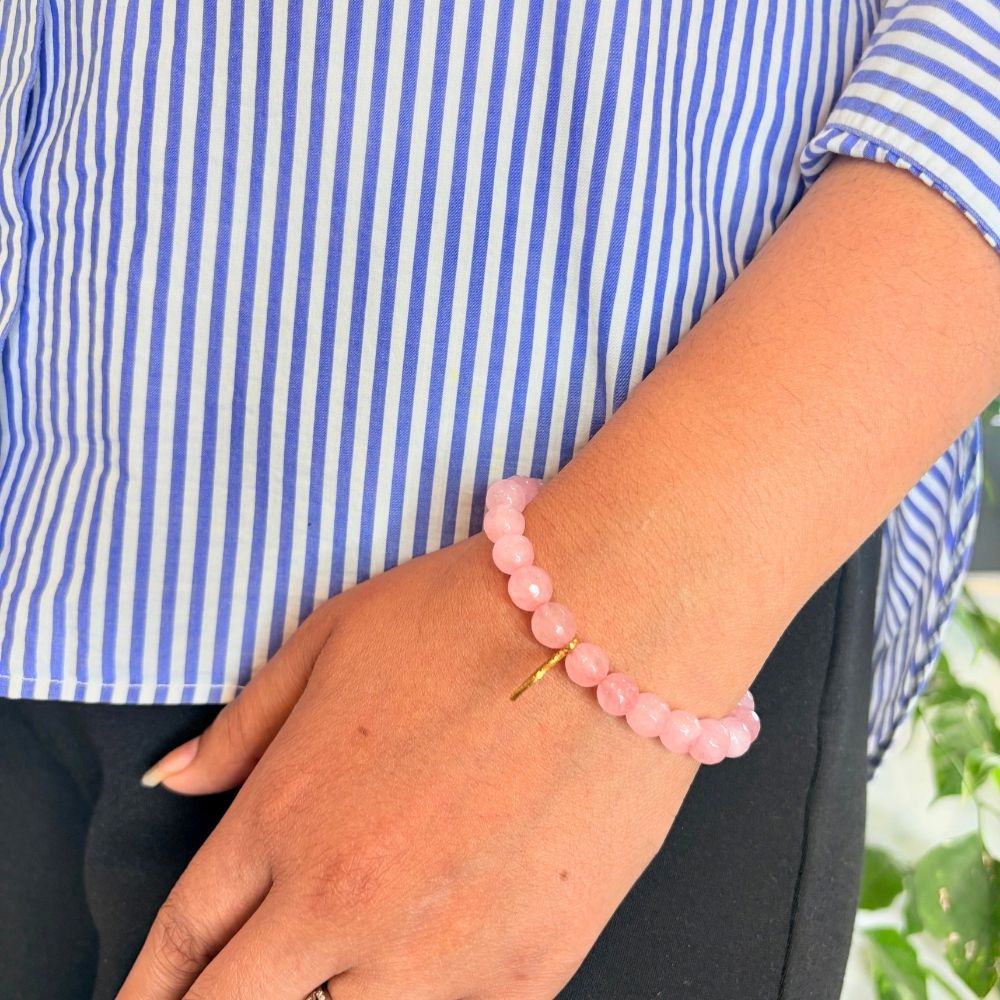 woman wearing a Rose Quartz Charm bracelet on her left hand