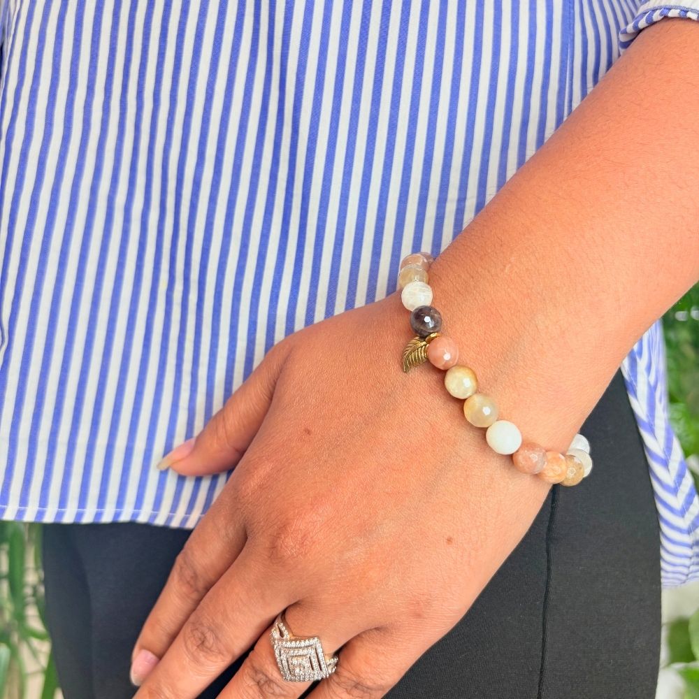 woman wearing a Sunstone Crystal Bracelet on her left hand