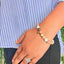 woman wearing a Sunstone Crystal Bracelet on her left hand