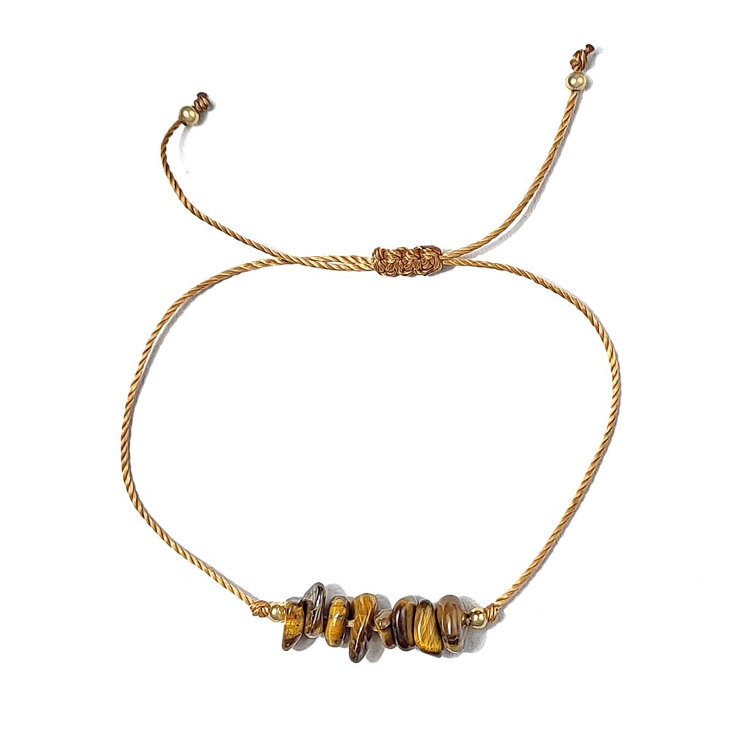 golden thread bracelet with  tiger eye stone beads on a white background