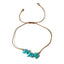 golden thread bracelet with turquoise stones on a white background