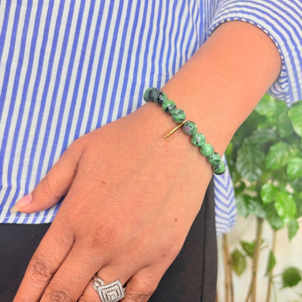 woman wearing a Zoisite Crystal bracelet on her left hand