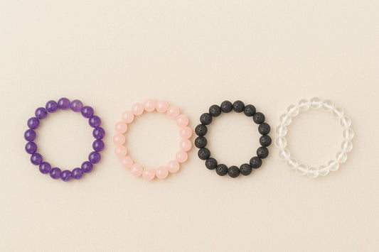 4 bracelets of colour purple, pink, black, transparent whiite