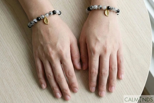 A person wearing Black Rutile Quartz bracelets on both left and right hands, showing the choice.