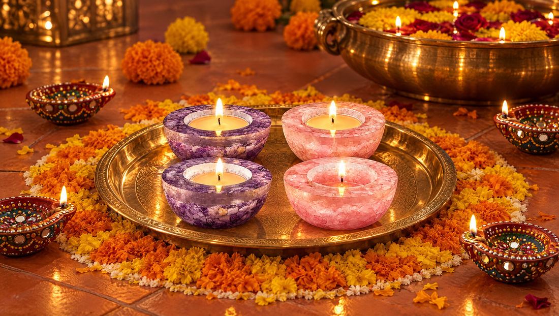 Amethyst and rose quartz crystal diyas on a brass plate inside a marigold rangoli
