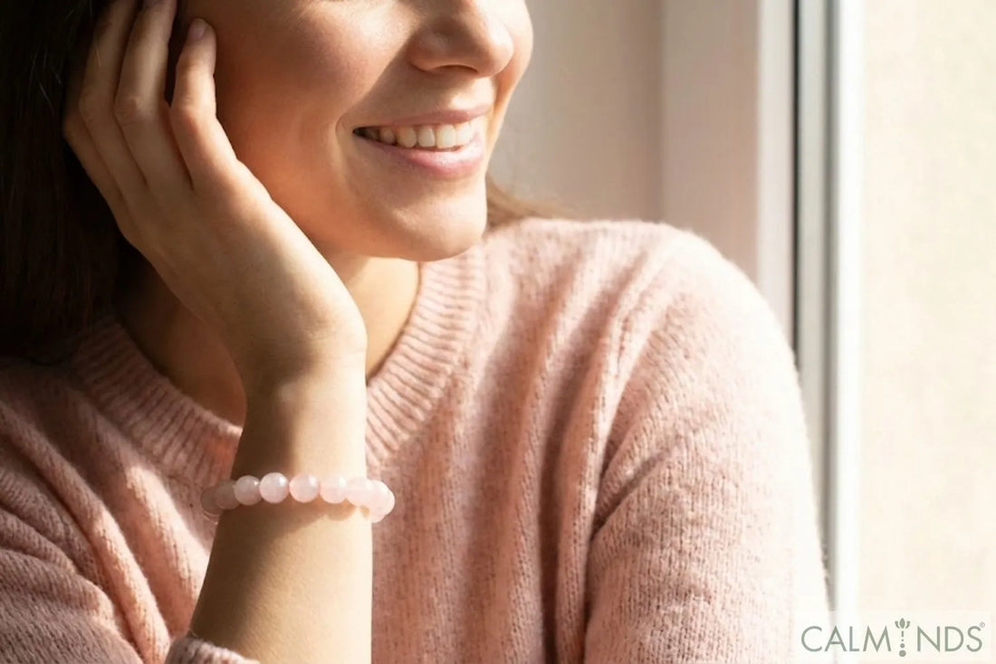 Happy woman wearing a Rose Quartz crystal bracelet, best Valentine gift for wife or girlfriend.