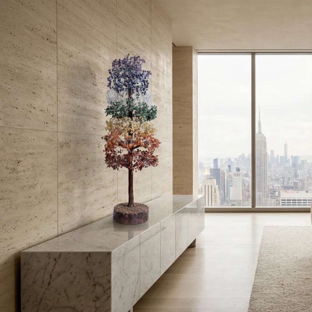 Decorative tree on a marble ledge with a cityscape view through large windows.