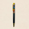Multicolored pen with gold accents on a beige background