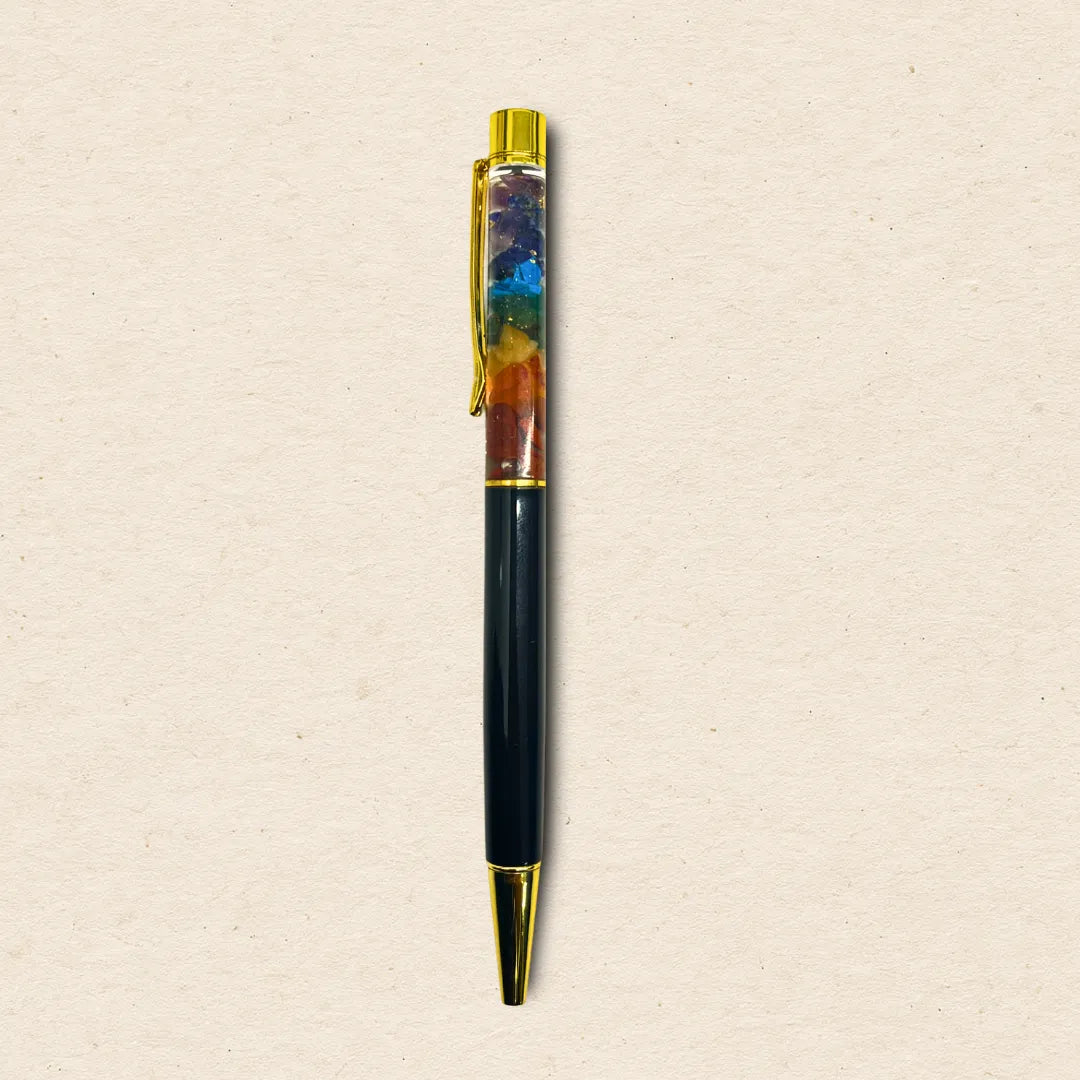 Multicolored pen with gold accents on a beige background