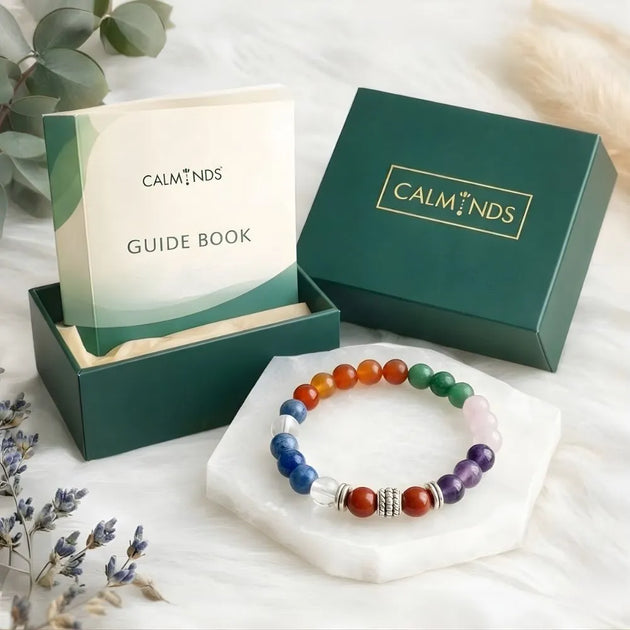 Crystal tree with red jasper and green aventurine on a wooden table in a living room setting.