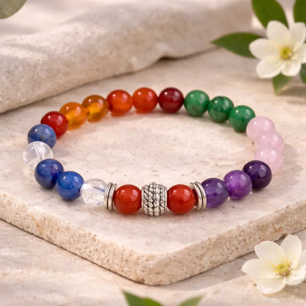 Colorful beaded bracelet on a white stand with 'Calminds' packaging and guide book on a light background.