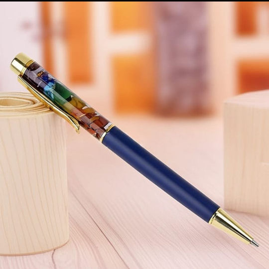 Blue pen with a decorative cap on a wooden surface