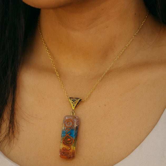Necklace with a colorful 7 chakra pendant worn by a girl