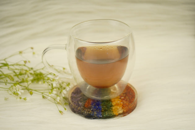 7 chakra orgonite coaster with a cup on top