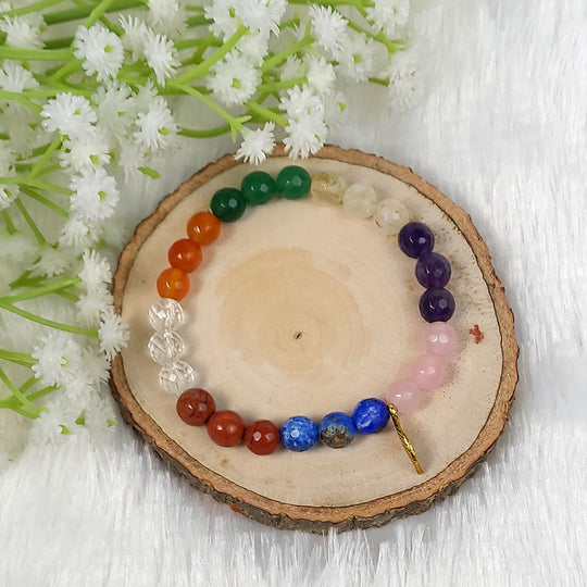 7 Chakra Crystal Bracelet on a wooden plate